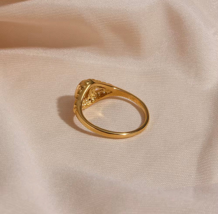 Close-up of Margot vintage freshwater pearl ring with detailed gold setting on jewelry cushion