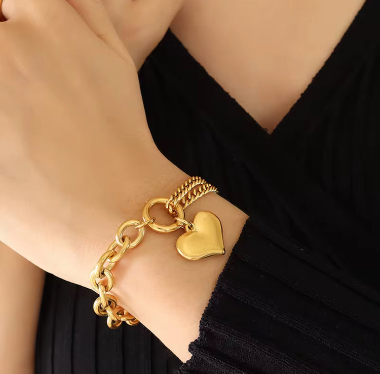This Heart Charm Bracelet exudes elegance with a modern, chic design. The delicate cuban and oval link chains are connected by a heart charm, making it a symbol of love and fashion. Wear this stunning bracelet as a reminder of your style and passion.
316L Stainless Steel
6.5 inches long+ 2 " extension
Non Tarnish, Hypoallergenic and water resistant.