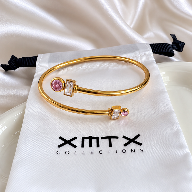 Delia pink and clear crystal gold bangle bracelet worn on wrist