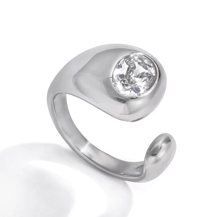 Silver Jennie Ring with polished sculptural band and round crystal stone on white background.