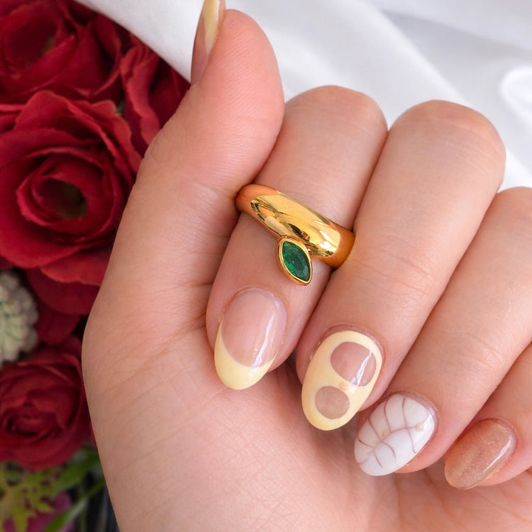 Close-up of Natalie Ring statement gold ring with green marquise stone