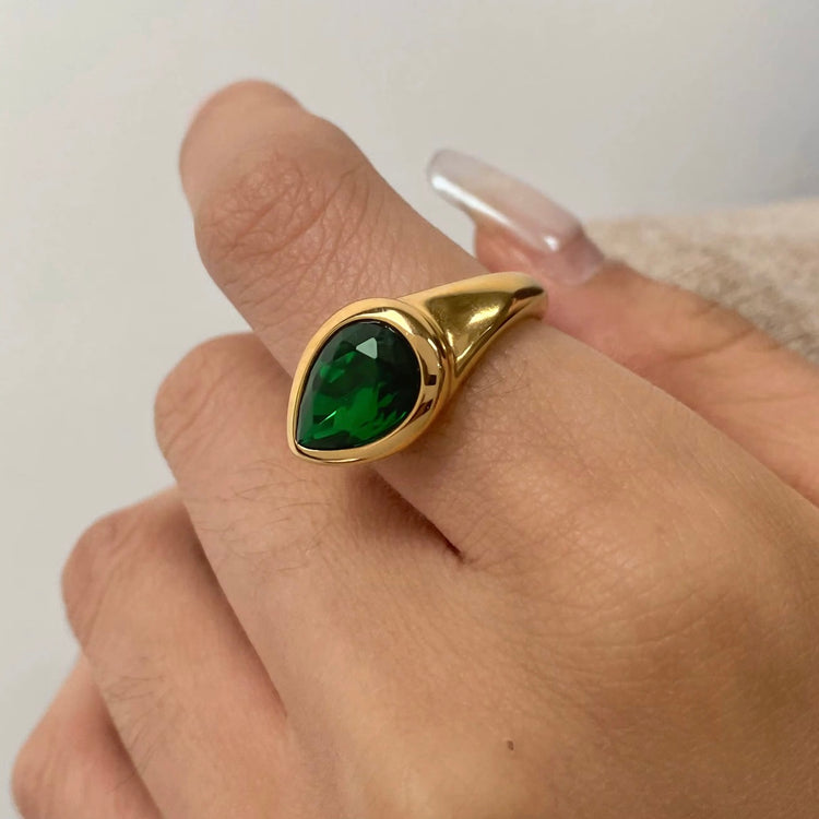Expertly designed, the Ivy Ring features a stunning tear-shaped deep green gemstone that adds a modern statement to any ensemble. Crafted with precision and style, this accessory exudes elegance and sophistication, making it a must-have for any fashion-forward individual.
Green Zircon
Stainless Steel 18K Gold PVD Plated - Made to last!
Hypoallergenic, Tarnish free Beach & Pool Friendly