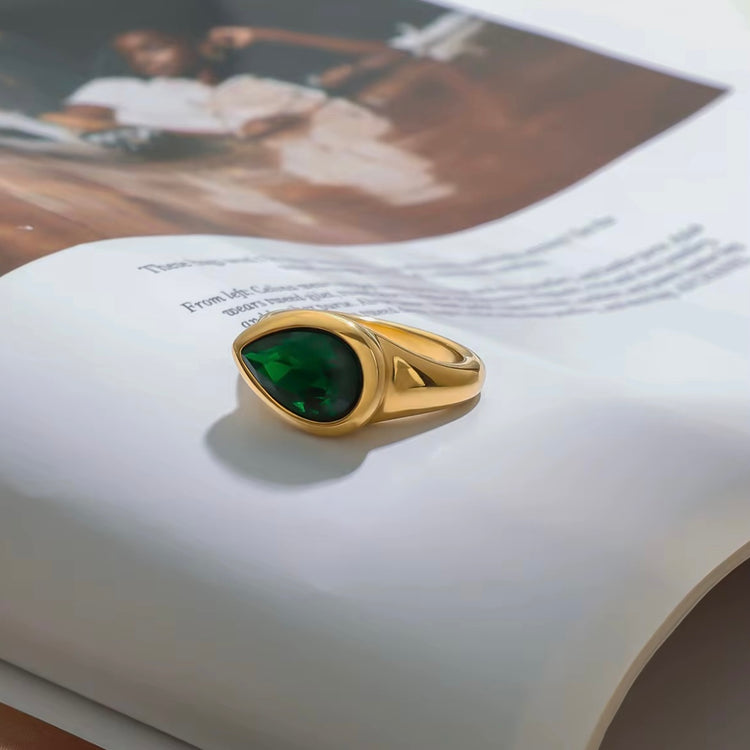 Expertly designed, the Ivy Ring features a stunning tear-shaped deep green gemstone that adds a modern statement to any ensemble. Crafted with precision and style, this accessory exudes elegance and sophistication, making it a must-have for any fashion-forward individual.
Green Zircon
Stainless Steel 18K Gold PVD Plated - Made to last!
Hypoallergenic, Tarnish free Beach & Pool Friendly
