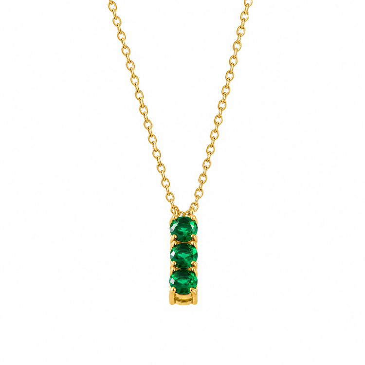A gold chain necklace with a vertical bar pendant featuring four round-cut green emerald-cut gemstones, shown on a plain white background.