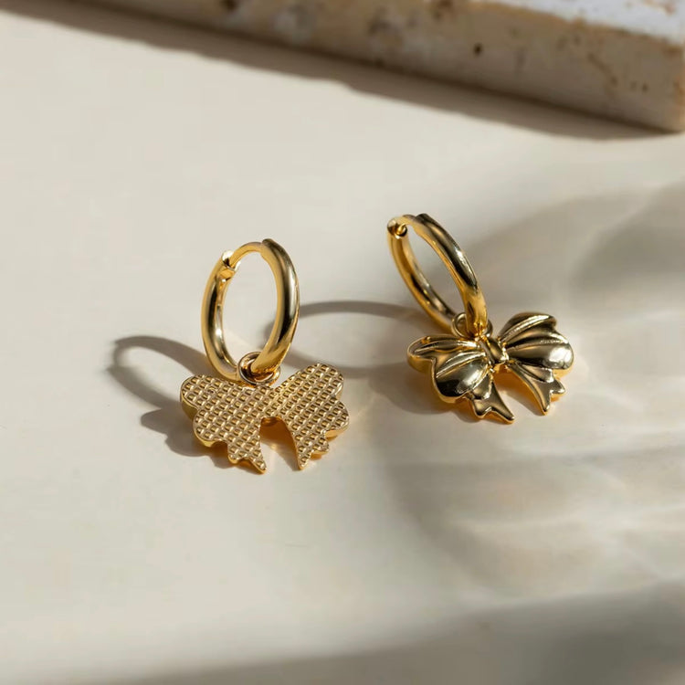 Embrace the latest trend with our must-have Bow Huggies Earrings. These cute accessories add a touch of charm to any outfit. Expertly crafted and designed to hug the ear, they are the perfect addition to your jewelry collection.
Made to last! Tarnish and Water Resistant, Beach & Shower friendly, Hypoallergenic
.82" total length from the hoop the the tip of the bow
18K Gold Plated over 316L Stainless Steel base