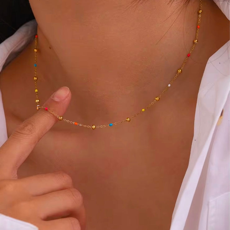 Add a pop of color to your summer look with our super dainty Colorful Enamel Small Beads Chain! Not only does it scream summer, but it's also water resistant and won't tarnish. Stay stylish all season long!

Made to last! Tarnish and Water Resistant, Hypoallergenic



16 inches long + 2 inches ext 

Closure :Lobster Clasp



18k Gold PVD Plated over 316L Stainless Steel base.  



