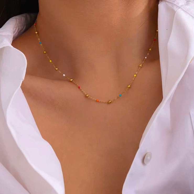 Add a pop of color to your summer look with our super dainty Colorful Enamel Small Beads Chain! Not only does it scream summer, but it's also water resistant and won't tarnish. Stay stylish all season long!

Made to last! Tarnish and Water Resistant, Hypoallergenic



16 inches long + 2 inches ext 

Closure :Lobster Clasp



18k Gold PVD Plated over 316L Stainless Steel base.  



