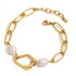 Coralie bracelet featuring chunky gold chain links and freshwater pearls