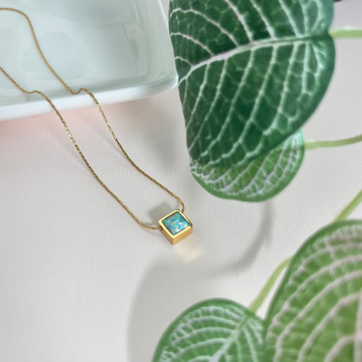 The Autumn Opal Square Pendant Necklace adds a touch of elegance to any outfit, featuring a beautiful, dainty design. The opal stone symbolizes hope and inner peace. With its non-tarnish and water-resistant properties, this necklace offers both style and durability.