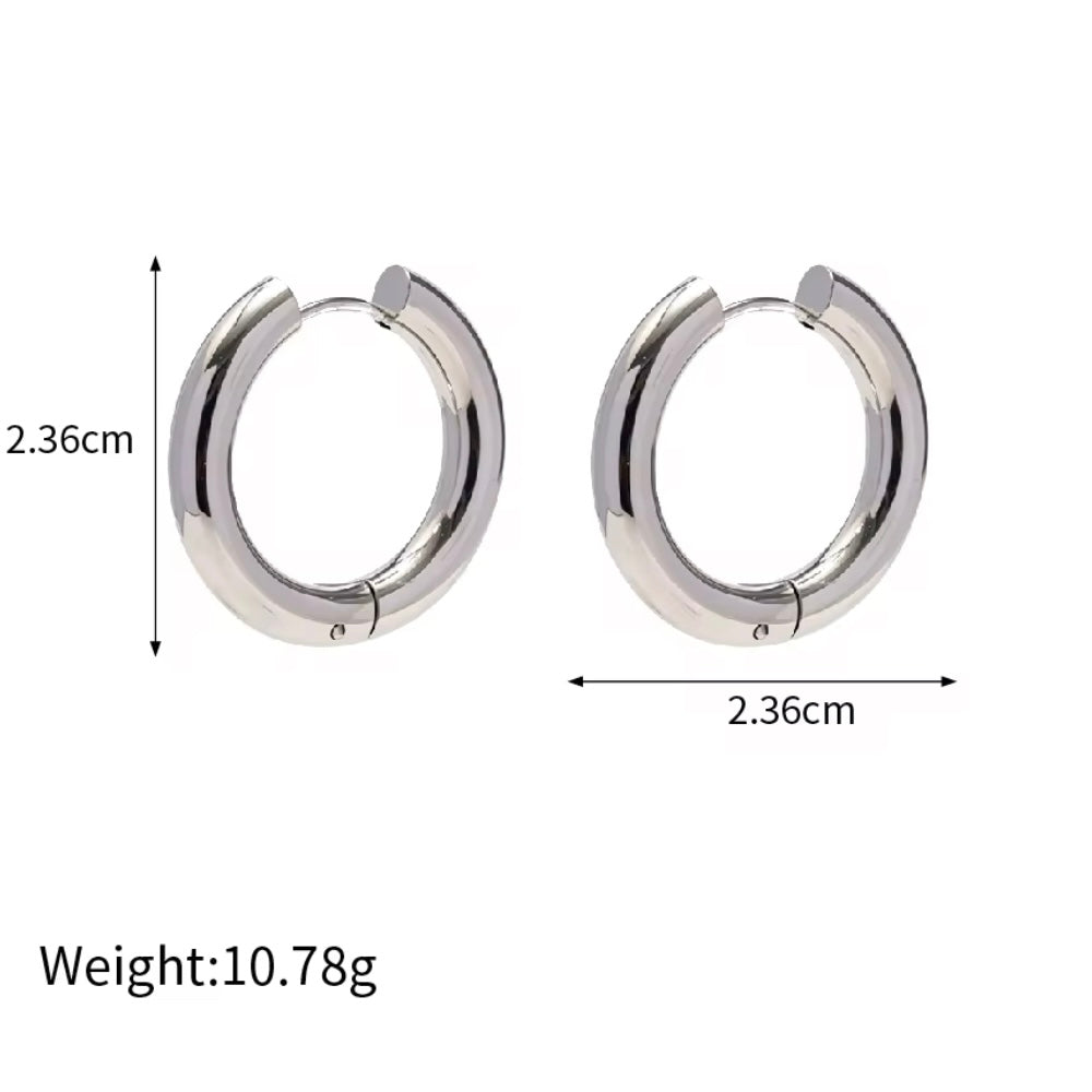 Indulge in the timeless elegance of our Celine Silver Hoop Earrings. Classic and must-have, these earrings are the perfect addition to any outfit. Elevate your style and make a statement with these exquisite hoops. You won&