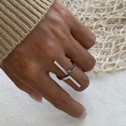 Inspire your style with our Tetris Open Ring! Embrace the geometric, unique design of this minimalistic piece. Stand out from the crowd with a touch of modernity and sophistication. Elevate any outfit and make a statement with this one-of-a-kind ring.

Metal:&nbsp; Stainless Steel

Hypoallergenic &amp; Water Resistant

Size: Adjustable Fits size 8/9