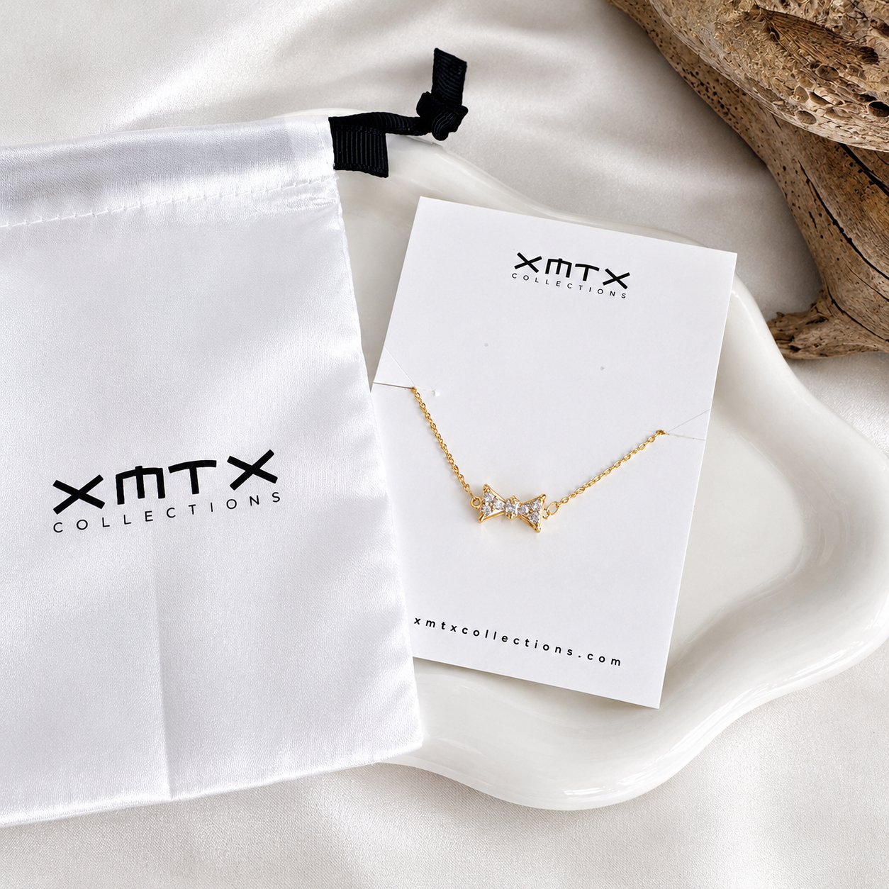 Bow Rhinestone Necklace presented on XMTX Collections jewelry card with white satin pouch
