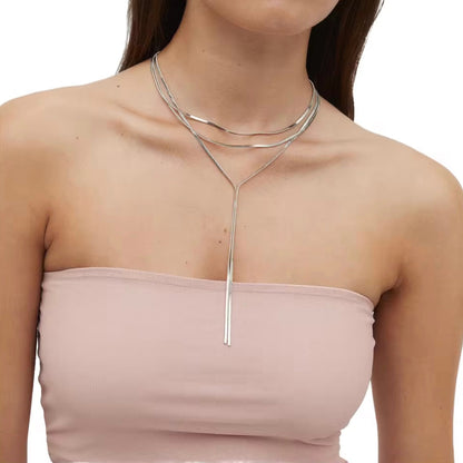 Model wearing Lonnie Y Snake Necklace in silver layered style