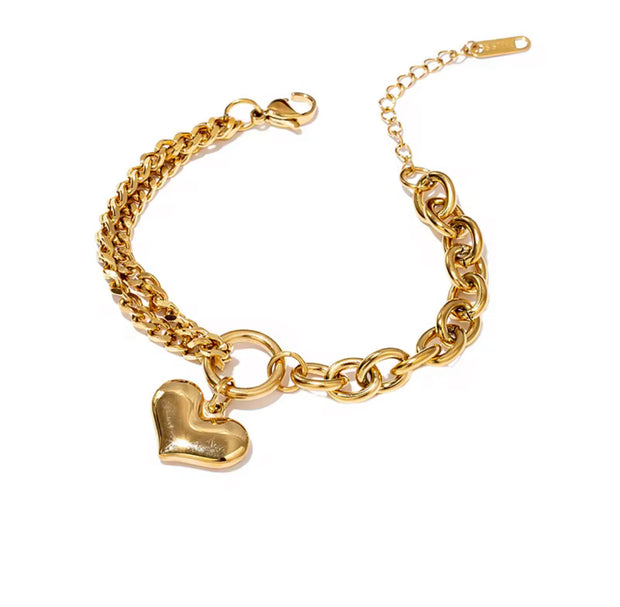 This Heart Charm Bracelet exudes elegance with a modern, chic design. The delicate cuban and oval link chains are connected by a heart charm, making it a symbol of love and fashion. Wear this stunning bracelet as a reminder of your style and passion.

316L Stainless Steel 

6.5 inches long+ 2 " extension

Non Tarnish, Hypoallergenic and water resistant.