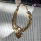 This Heart Charm Bracelet exudes elegance with a modern, chic design. The delicate cuban and oval link chains are connected by a heart charm, making it a symbol of love and fashion. Wear this stunning bracelet as a reminder of your style and passion.

316L Stainless Steel 

6.5 inches long+ 2 " extension

Non Tarnish, Hypoallergenic and water resistant.