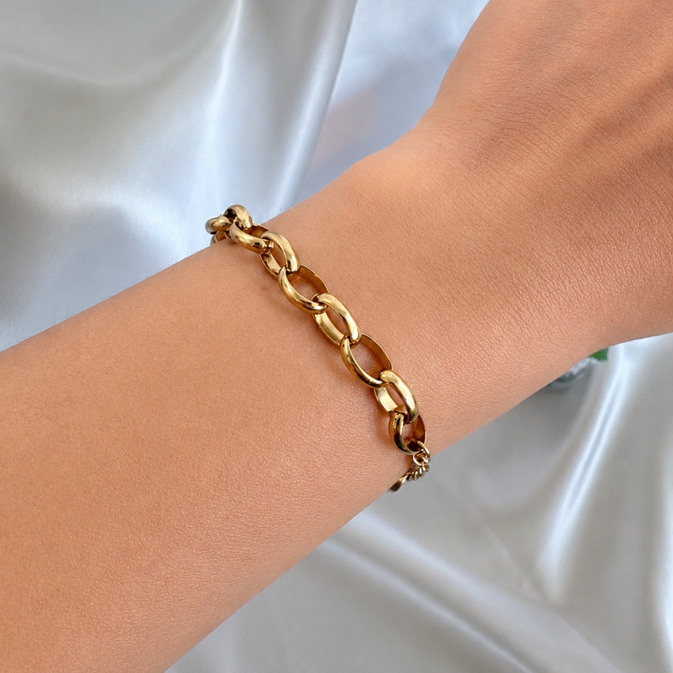elongated-oval-link-bracelet-on-arm-satin-background-xmtx-collections