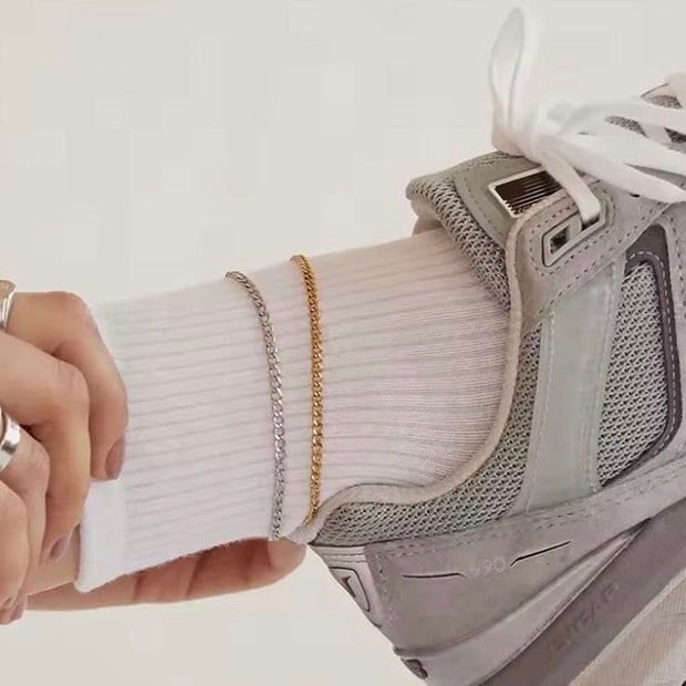 Thin Cuban Link Anklet XMTX Collections shown on a leg with a sneaker on