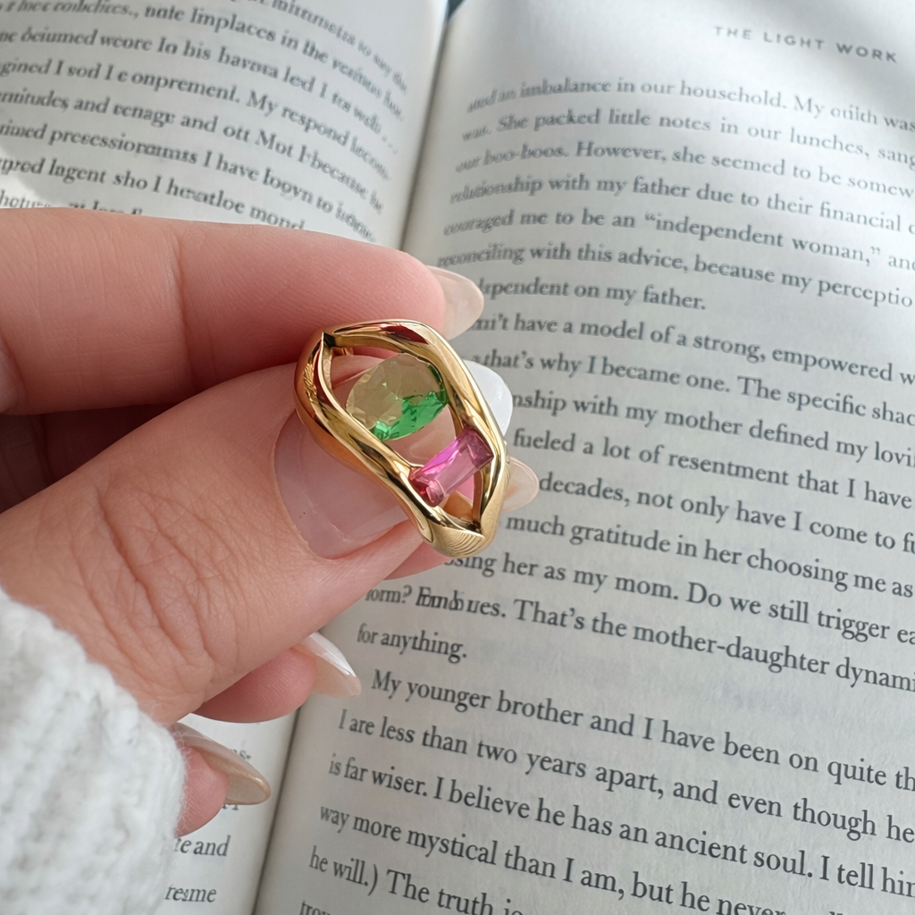 Alissa gold statement ring worn on hand with green and pink stones lifestyle shot