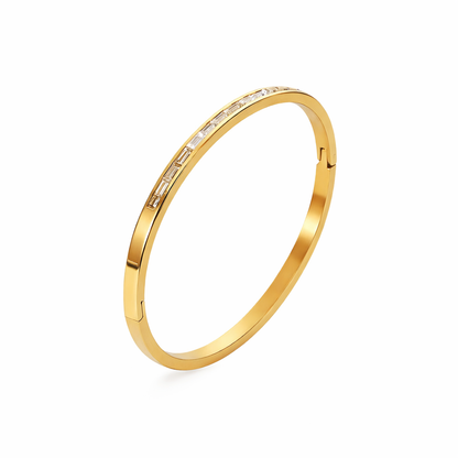Gold Ally bangle bracelet with Gold Ally bangle bracelet with baguette-cut stones on a white background
