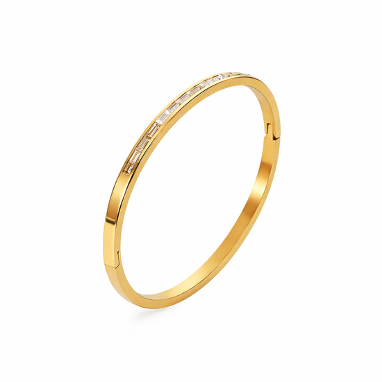 Gold Ally bangle bracelet with Gold Ally bangle bracelet with baguette-cut stones on a white background