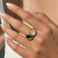 Close-up lifestyle photo of the Aster waterproof gold statement ring on a hand
