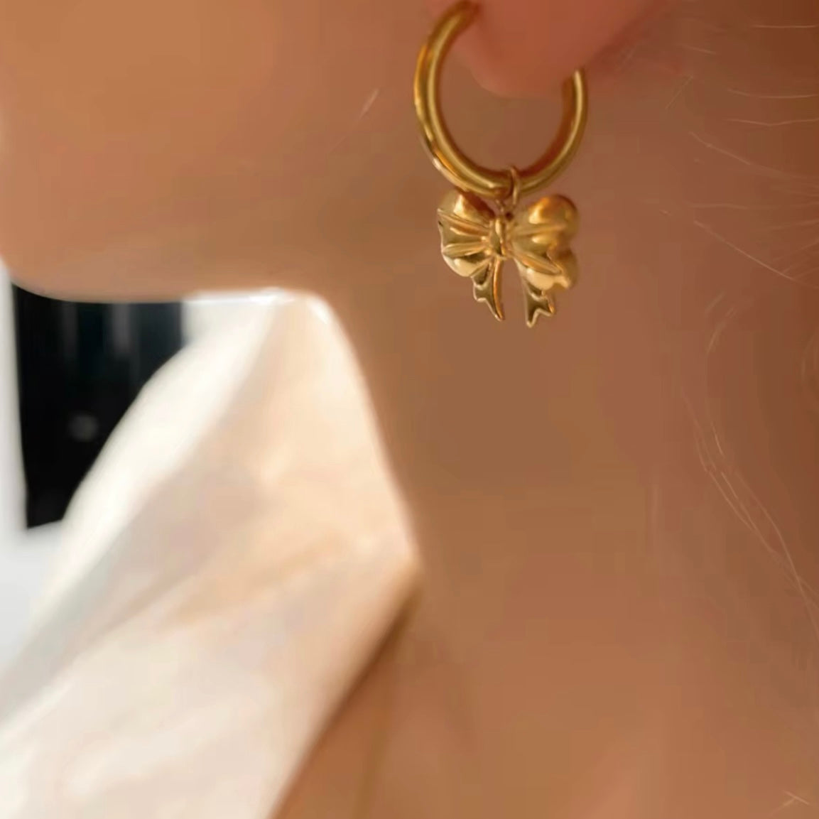 Embrace the latest trend with our must-have Bow Huggies Earrings. These cute accessories add a touch of charm to any outfit. Expertly crafted and designed to hug the ear, they are the perfect addition to your jewelry collection.

Made to last!&nbsp;Tarnish and Water Resistant, Beach &amp; Shower friendly, Hypoallergenic

.82" total length from the hoop the the tip of the bow

18K Gold Plated over 316L Stainless Steel base