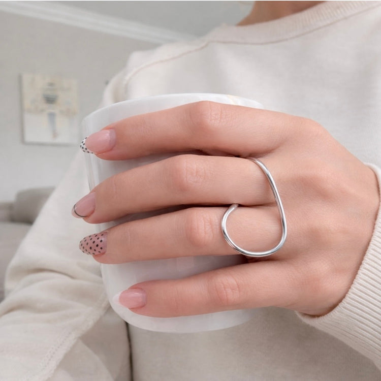 Billy Geometric Double Ring in silver worn on hand holding cup – modern statement ring styling