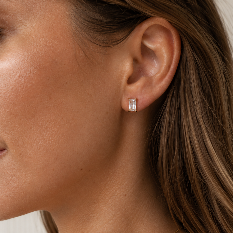 Model wearing Brenda waterproof gold emerald-cut cubic zirconia stud earrings.