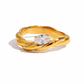 Cerise Ring with twisted gold stainless steel band and oval cubic zirconia on white background