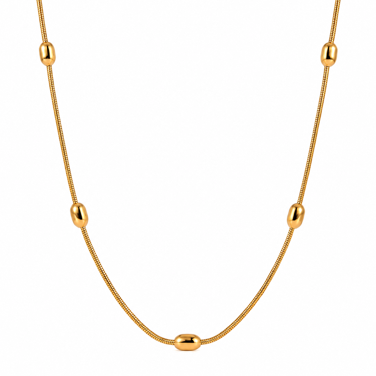 Gold snake chain necklace with oval bead accents on a white background