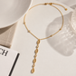 Flat lay of the Christina Drop Necklace showcasing gold oval links and sparkling cubic zirconia details.