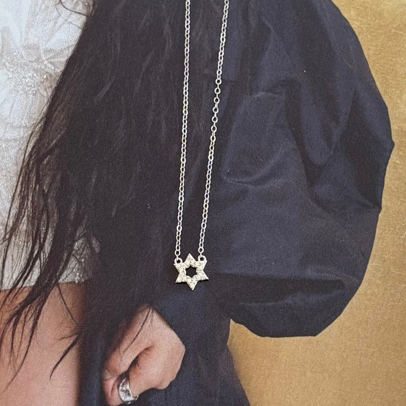 Minimalist Star of David necklace styled for everyday wear, showcasing delicate Jewish jewelry design.