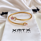 Delia pink and clear crystal gold bangle bracelet worn on wrist