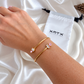 Delia gold bangle with pink and clear crystal details