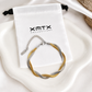 Double snake bracelet displayed on XMTX Collections jewelry pouch