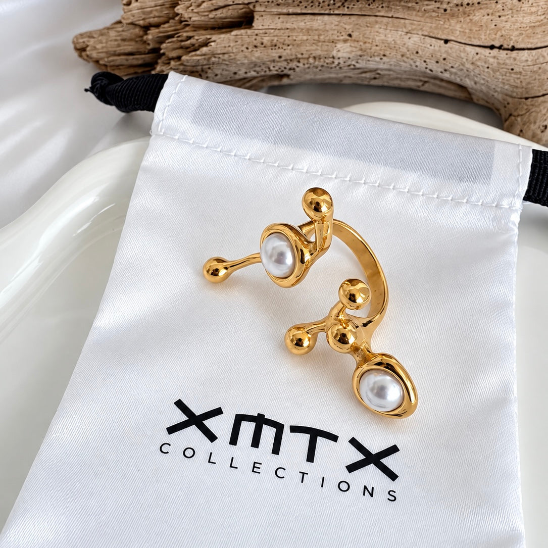 Ellen Modern gold statement ring with faux pearl accents displayed on an XMTX Collections satin jewelry pouch.