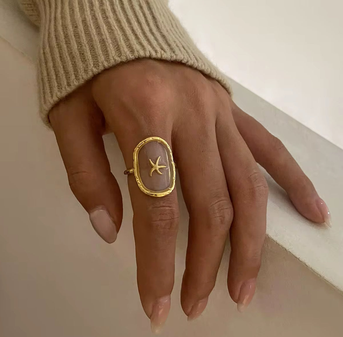 This See Through Starfish Ring is perfect for adding a touch of beach vibes to your summer wardrobe. Its unique design allows for a see through effect, making it a truly unique piece. Get ready to stand out with this one of a kind ring. Made for the summer sun and sand.

Fits SIZE - 7/ Open size

Stainless Steel 18K Gold PVD Plated - Made to last!

Hypoallergenic, Tarnish free&nbsp;