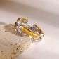 The Angelika Open Band Ring is a stunning embodiment of modern elegance and sophistication. With a seamless blend of gold and silver tones, this ring exudes luxury and versatility. Made with a durable and comfortable design, it is the perfect statement piece for any occasion.

Metal:&nbsp; Stainless Steel

Hypoallergenic &amp; Water Resistant

Size: 7 only