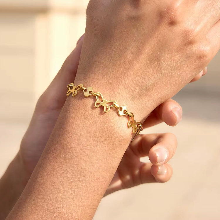 Gold butterfly bracelet on wrist dainty adjustable waterproof jewelry