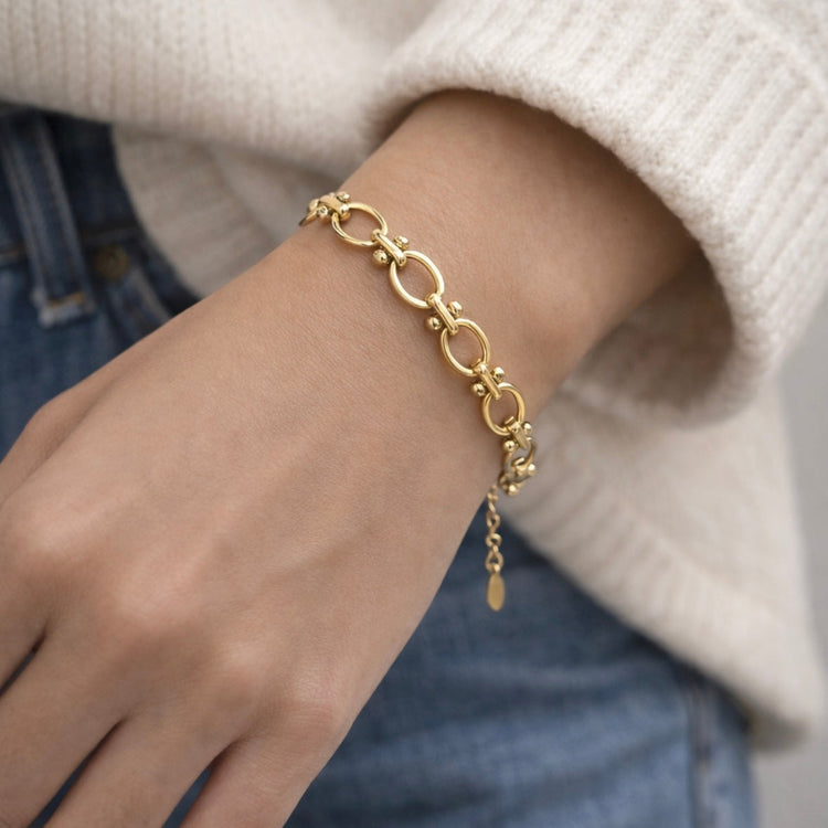 Gold oval link bracelet on model crafted from waterproof non-tarnish stainless steel with a modern chain design