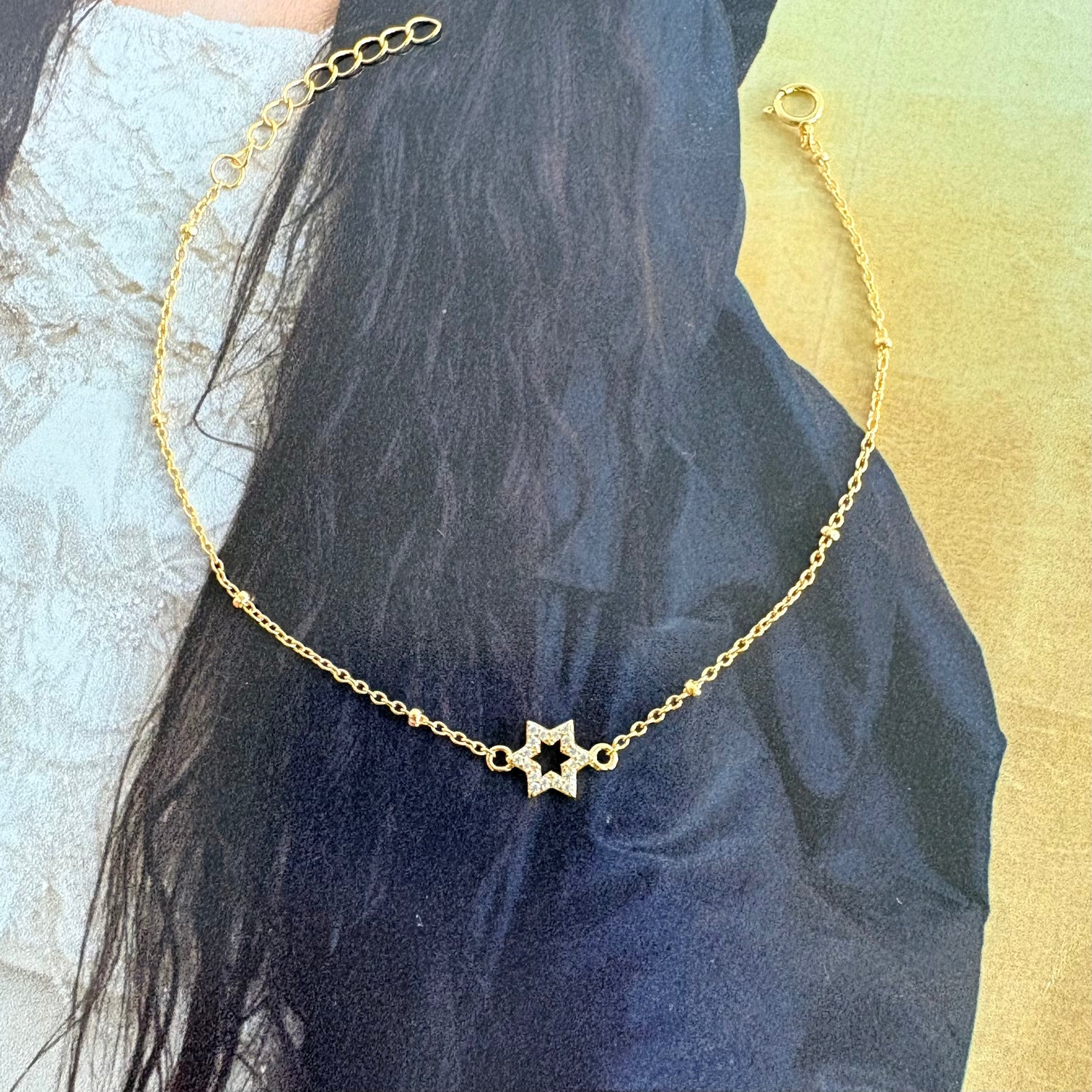 Minimalist gold pavé Star of David bracelet editorial styling