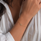 Woman wearing gold pavé Star of David bracelet in natural lighting