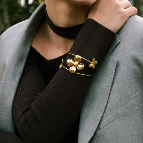 Flower & Butterflies Bangle Bracelet XMTX Collections model is wearing it over black sweater