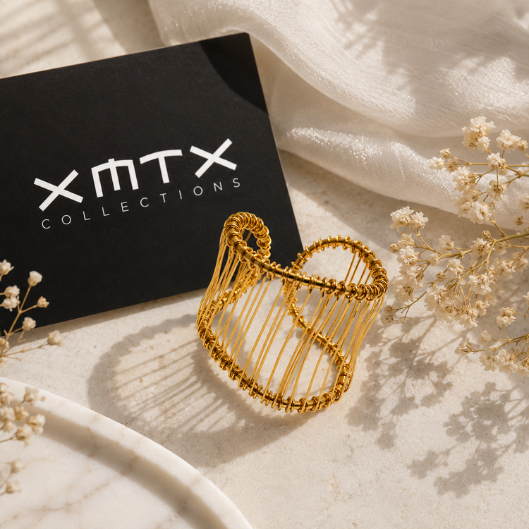 Hali Wire Ring styled in a luxury XMTX Collections flatlay with elegant neutral textures and branding