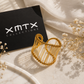 Hali Wire Ring styled in a luxury XMTX Collections flatlay with elegant neutral textures and branding