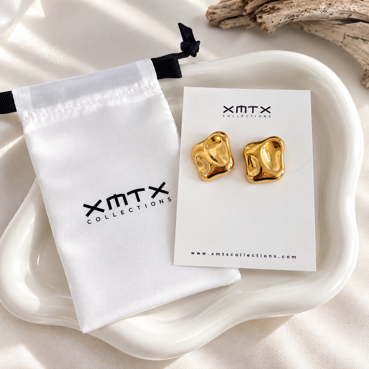 Hattie gold stud earrings in XMTX Collections packaging