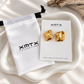 Hattie gold stud earrings in XMTX Collections packaging