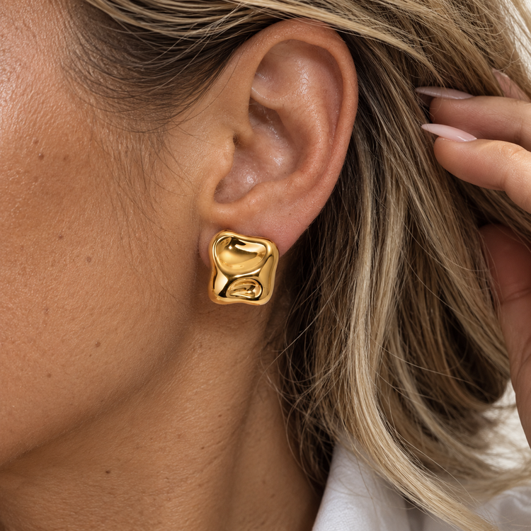 Hattie gold stud earrings worn on ear