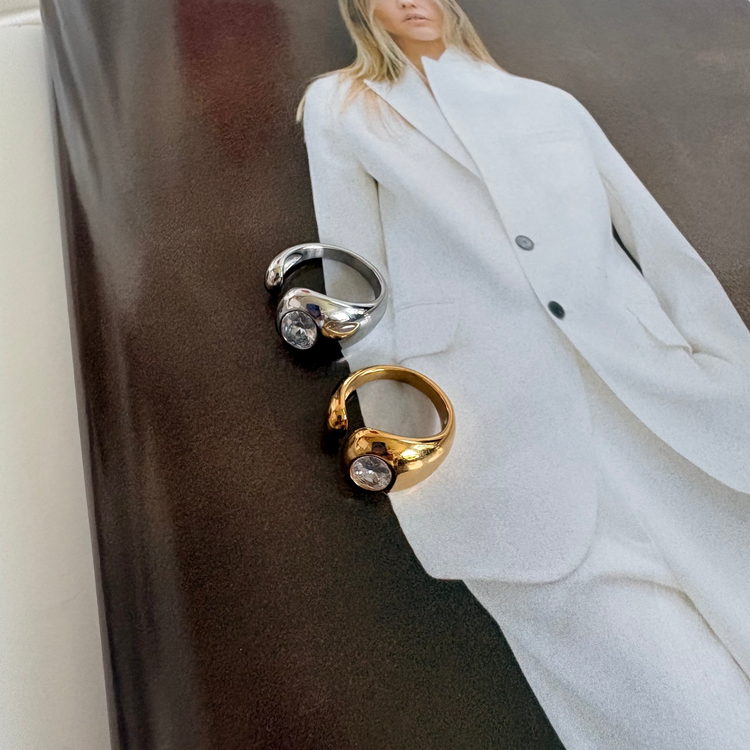 Gold and silver Jennie Ring displayed on magazine page, showing the sculptural silhouette and crystal detail