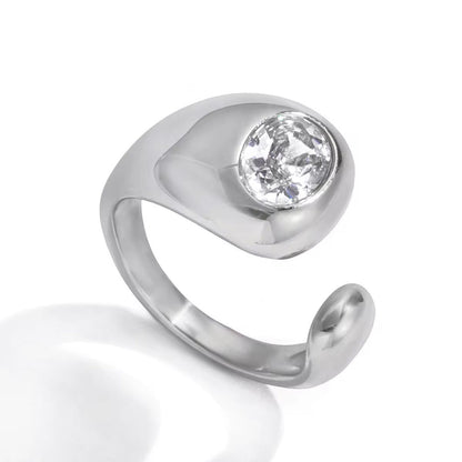 Silver Jennie Ring with polished sculptural band and round crystal stone on white background.